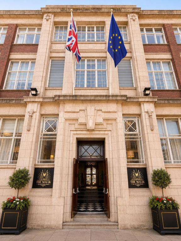 a building with two flags in front of it at The Malik - An Art Deco Hotel in Birmingham