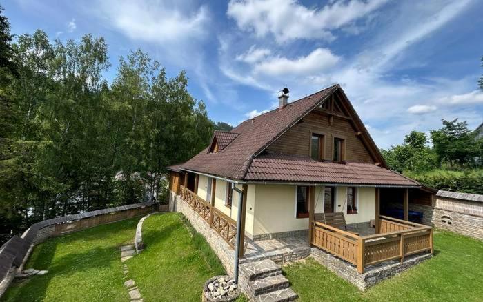 a small house with a roof on a yard at Chata Biely Potok in Oravský Biely Potok