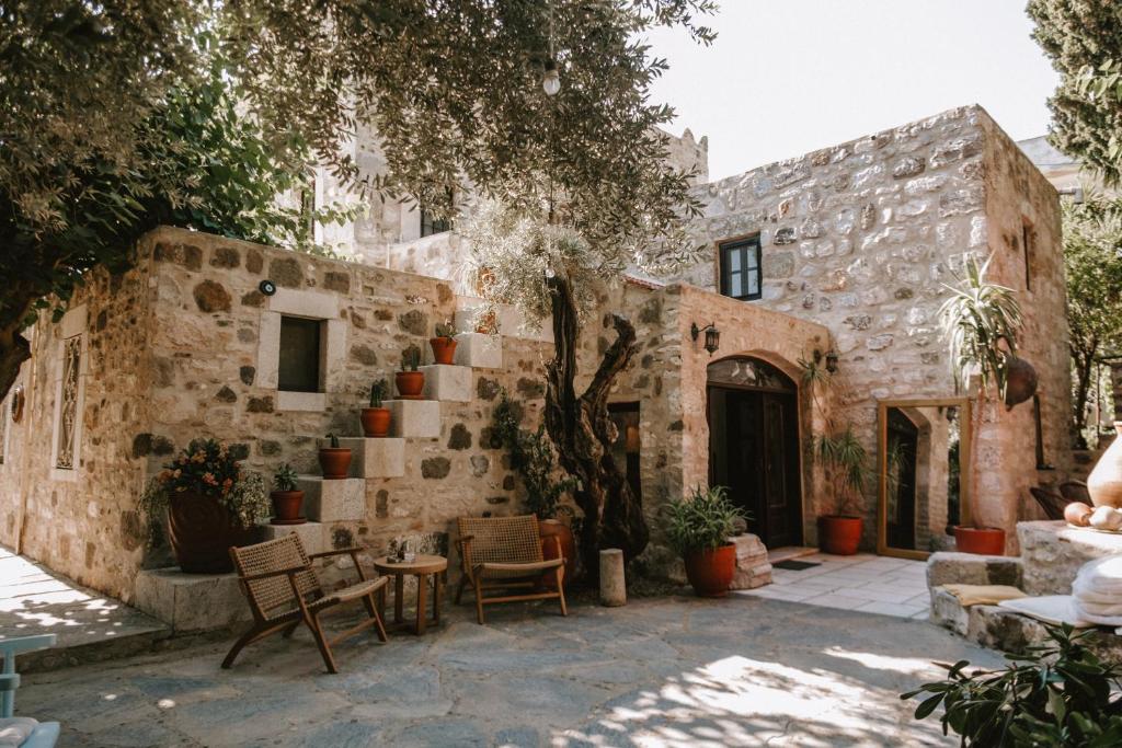 a stone house with a staircase in a courtyard at Boleka Bodrum in Bodrum City