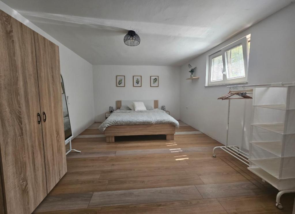 a bedroom with a bed in the middle of a room at Apartma Sofiora in Dekani