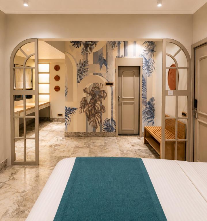 a bedroom with a bed with a green rug at MG Villa - A Boutique Stay in Navi Mumbai