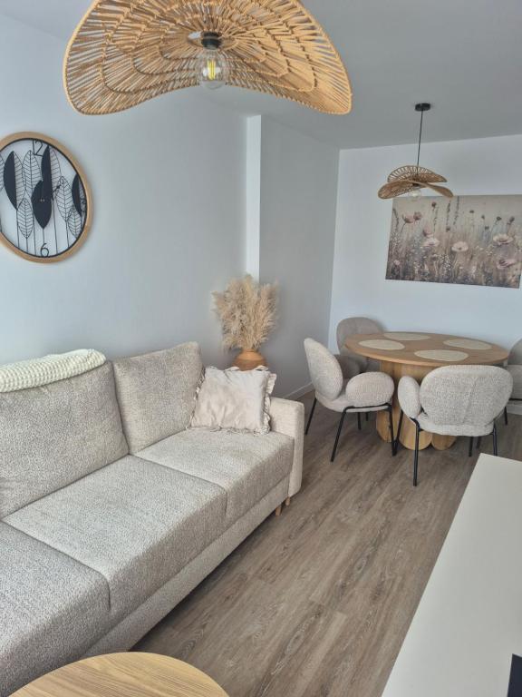 a living room with a couch and a table at Apartament HARMONY in Koszalin