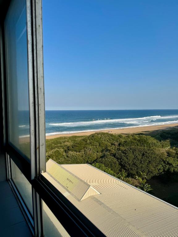 a view of the ocean from a room with a window at Afsaal 612 in Amanzimtoti