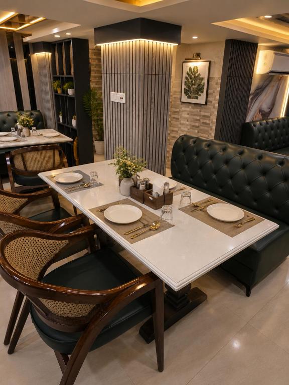 a dining room with a table and chairs at Comfort Sure in Amritsar