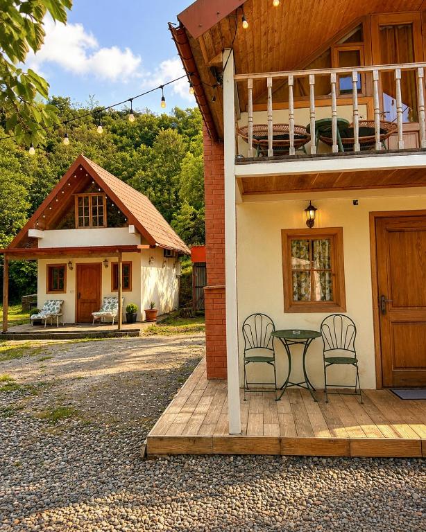 a house with a table and chairs on a patio at Love Corner in Batumi