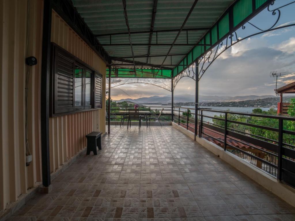 a balcony of a building with a view of the water at Beutiful view Cosy House with Starlink internet in Salamina