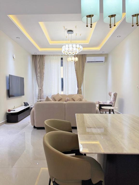 a living room with a couch and a table at Zabibu Residence in Nkongontha