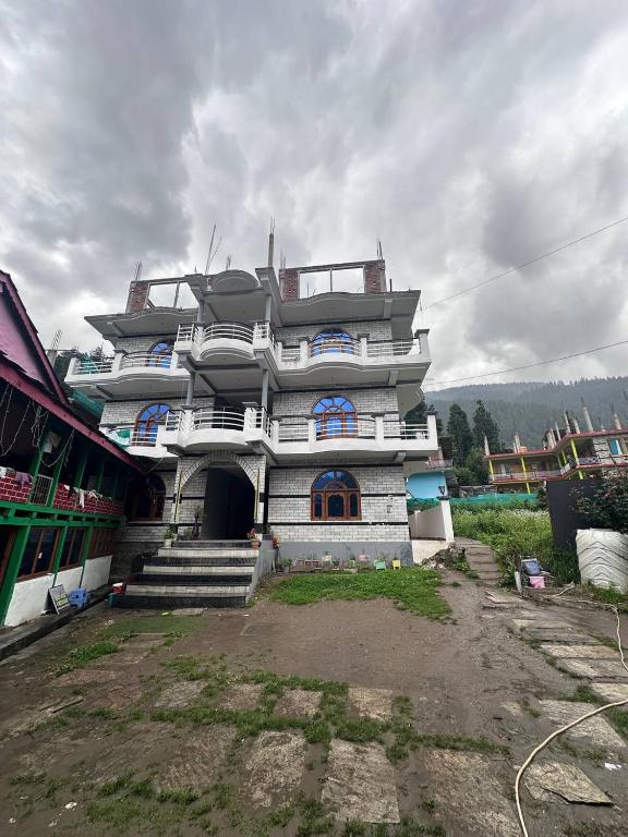 a large white building with stairs in front of it at Boom Shankar in Kalgha