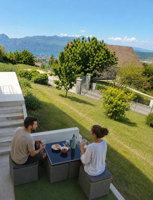 a man and a woman sitting at a table at Appartement indépendant dans maison au calme in Pugny-Chatenod