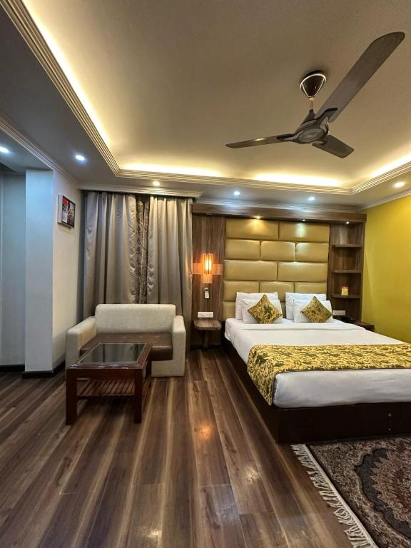 a hotel room with two beds and a ceiling fan at HOTEL ROYAL MILAD in Srinagar