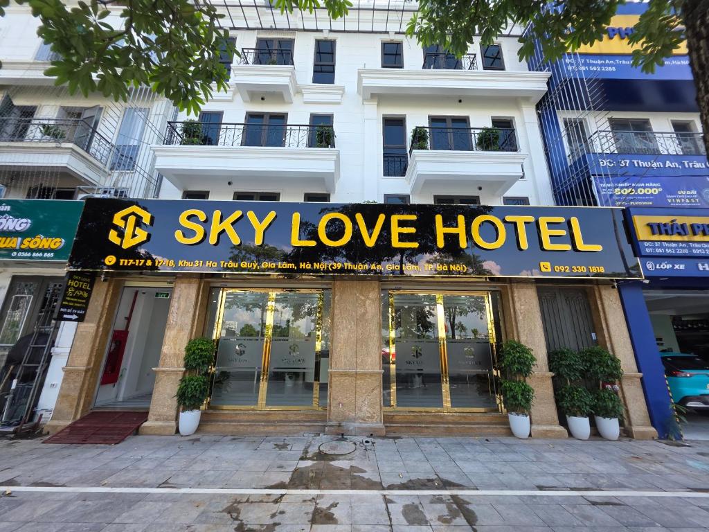 a sign for a sky love hotel in front of a building at Sky Love Hotel - Trâu Qùy in Thạch Cầu