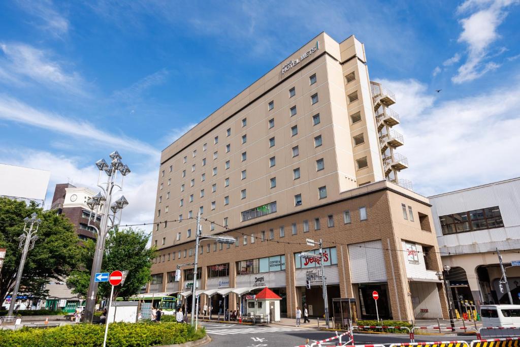 a large building on a city street with at JR-East Hotel Mets Koenji in Tokyo