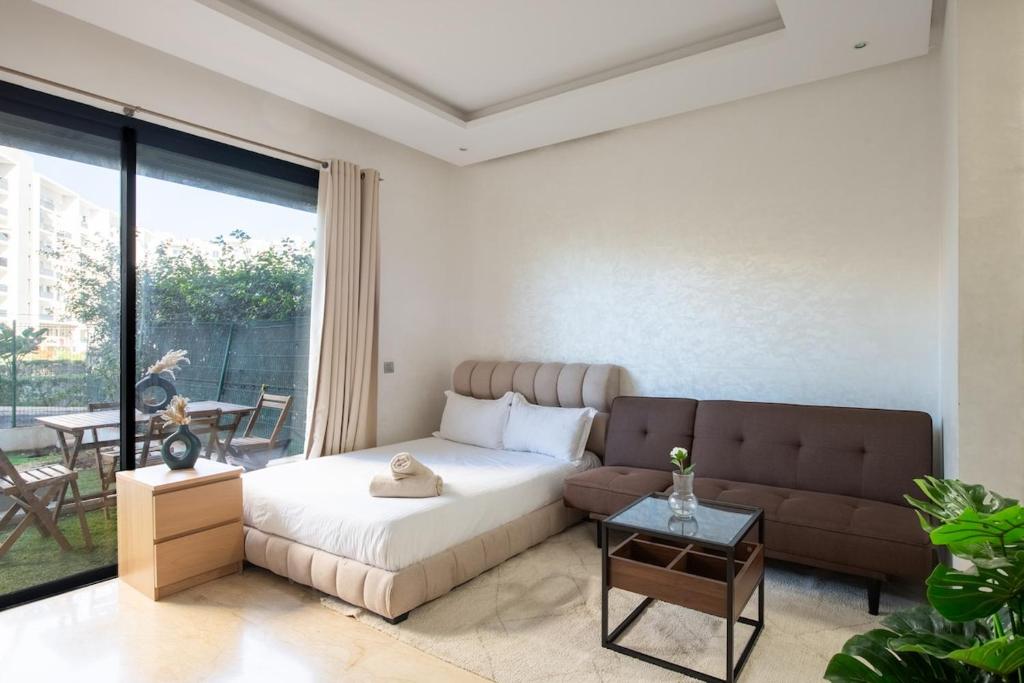 a bedroom with a bed and a couch at TT holidays Prestigia Hay Riad-Pool in Rabat