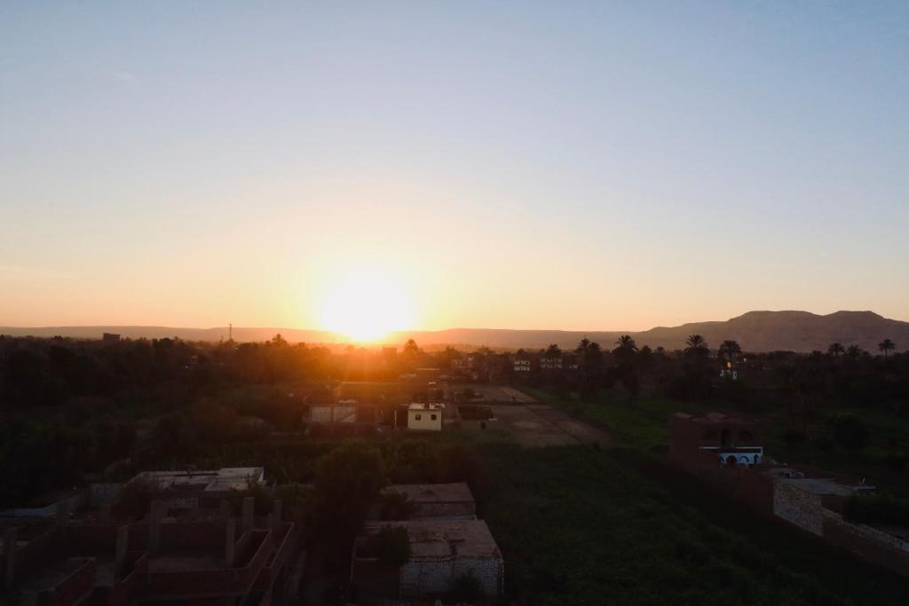an image of the sun setting over a city at Nile Kingdom Guest house in Luxor