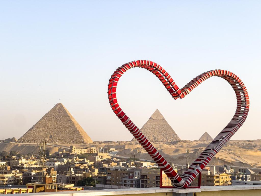 a pair of heart shaped candy canes in front of the pyramids at RAFiF Pyramids View Hotel in Cairo