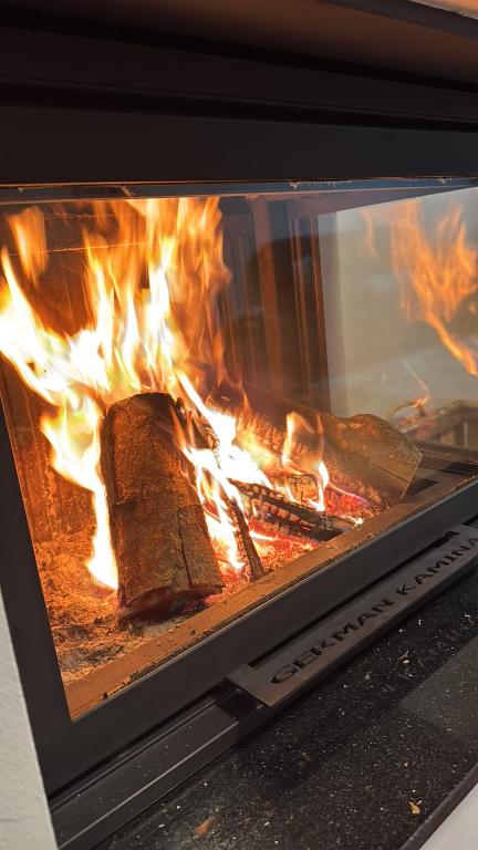 a fire in an oven with some food in it at Te Pishat in Brezovica