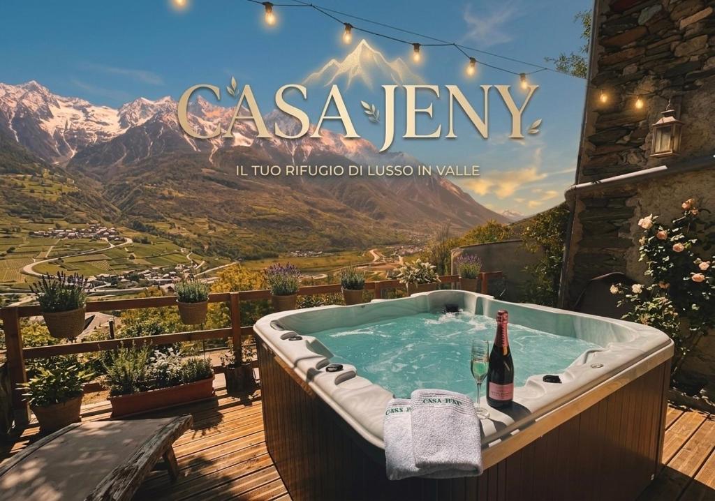 a hot tub with a bottle of wine and a book at Casa Jeny in Fenis