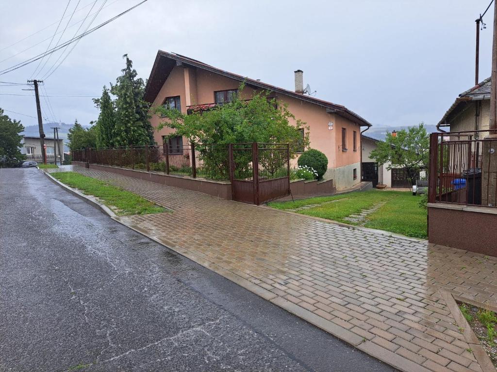 an empty street in front of a house at Apartmán PASOMA in Levoča