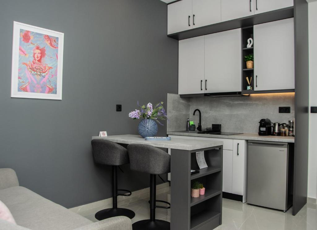 a kitchen with a counter and stools in a room at COMFY Apartments in Alexandroupoli