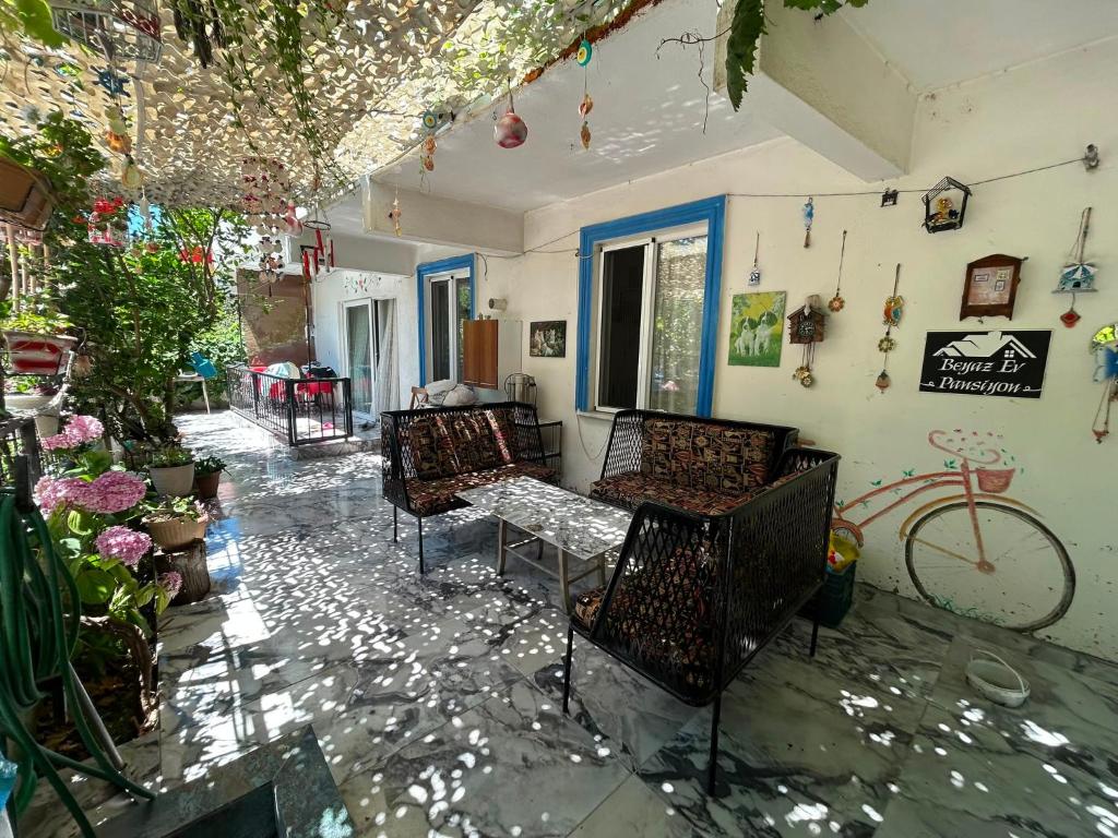 a patio with chairs and a bike in a house at BEYAZEV Apart in Erdek