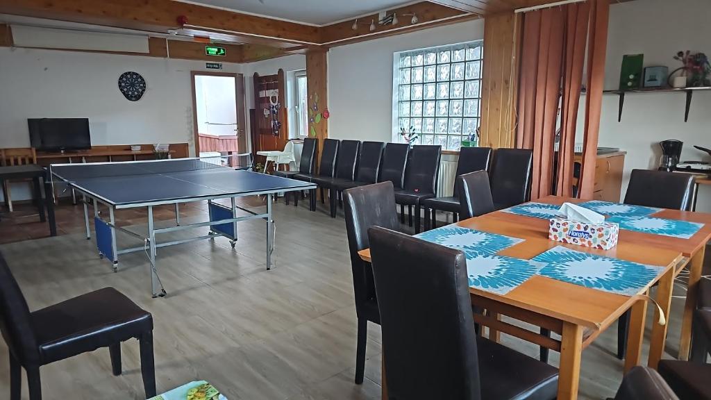 a dining room with a ping pong table and chairs at Apartament de vacanta Criss in Buşteni