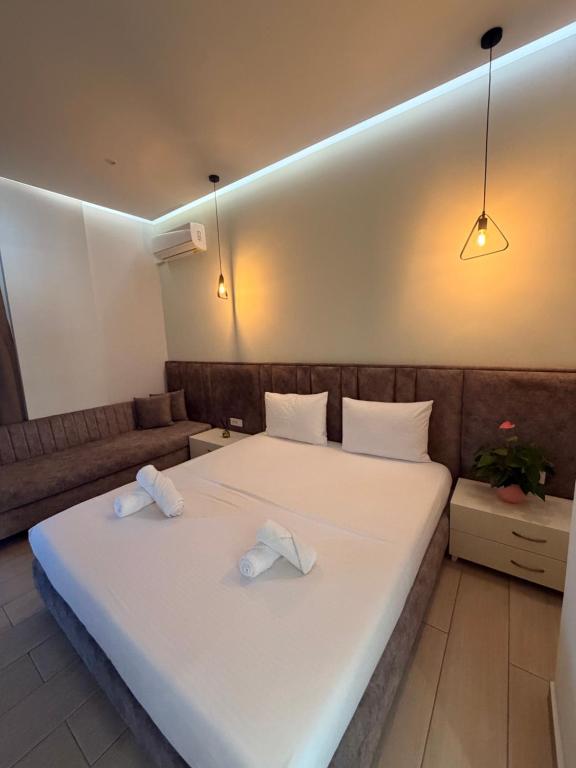 a bedroom with a bed with two towels on it at Hotel LIDI in Sarandë