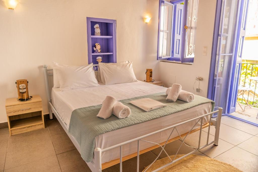a bedroom with a bed with towels on it at Kali Strata 2 - Downtown in Symi