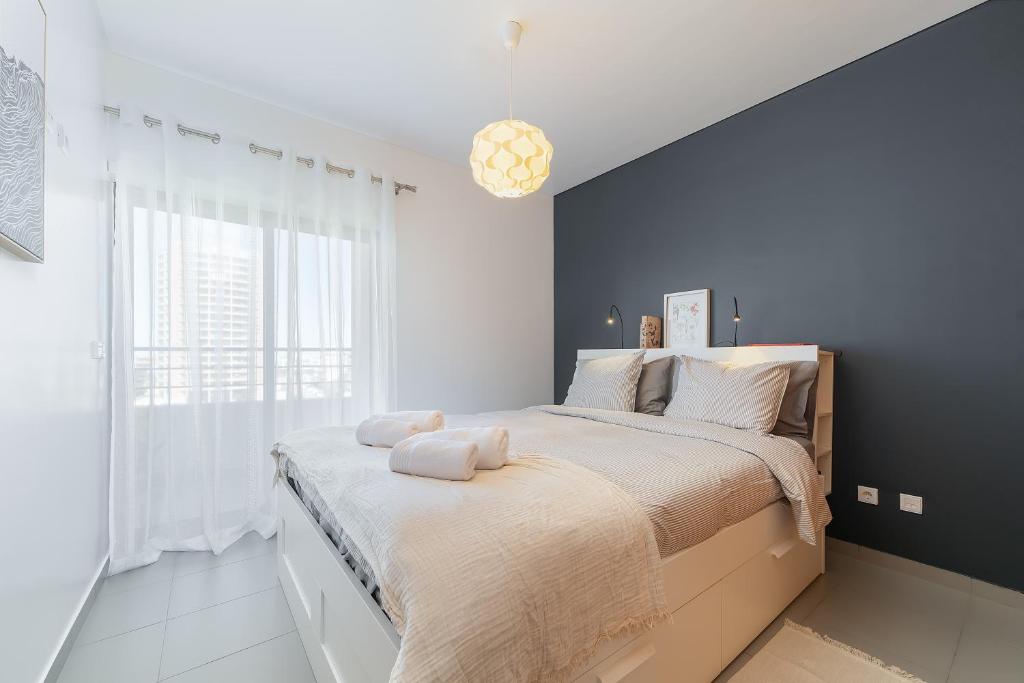 a bedroom with a large bed and a large window at Portimão, Praia da Rocha in Portimão