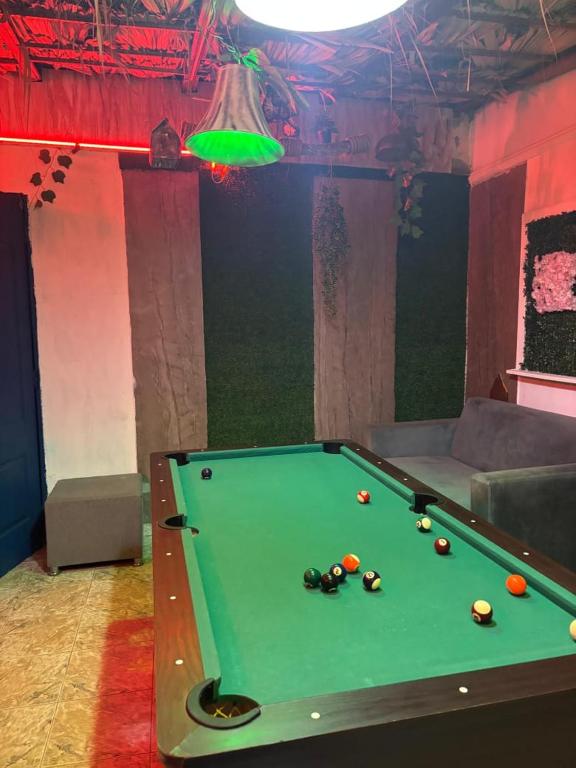 a pool table in a room with a green at Valle Romantico in Manoguayabo