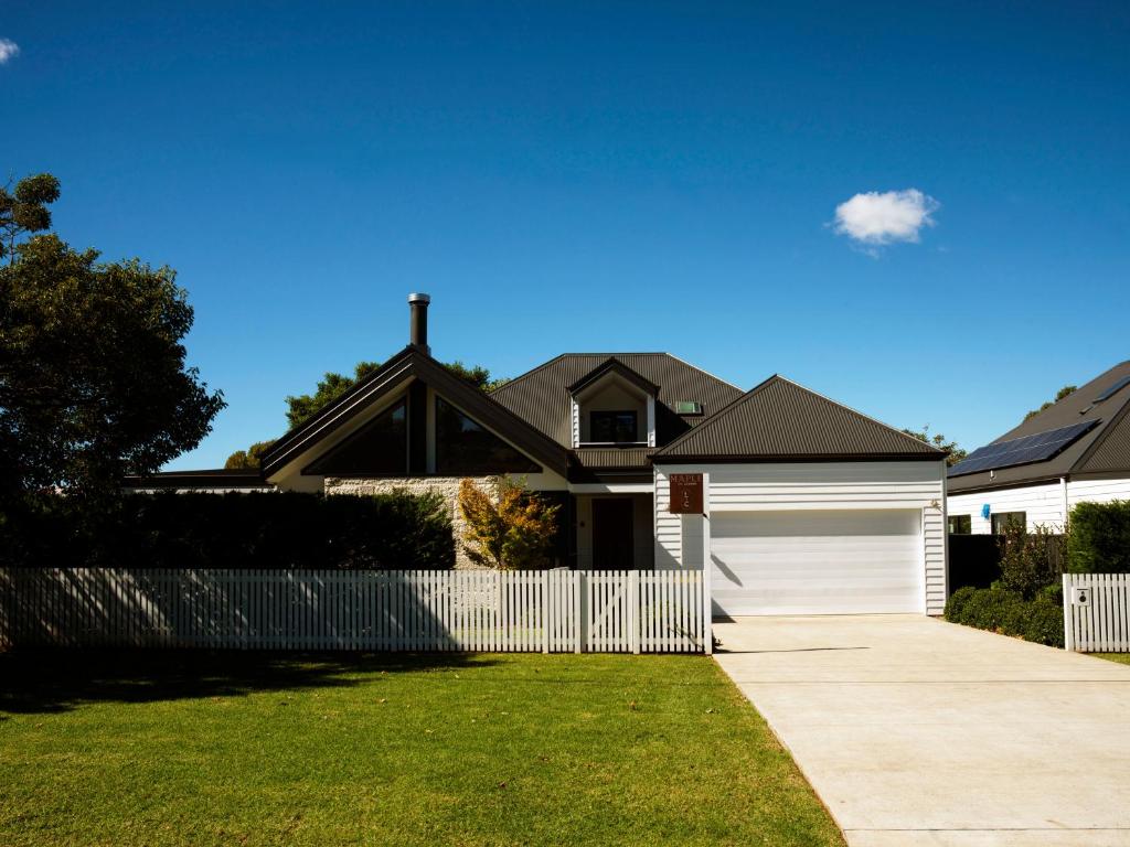 a house with a white fence and a driveway at Maple & Rubus, Berry - by Linnaeus Collection in Berry