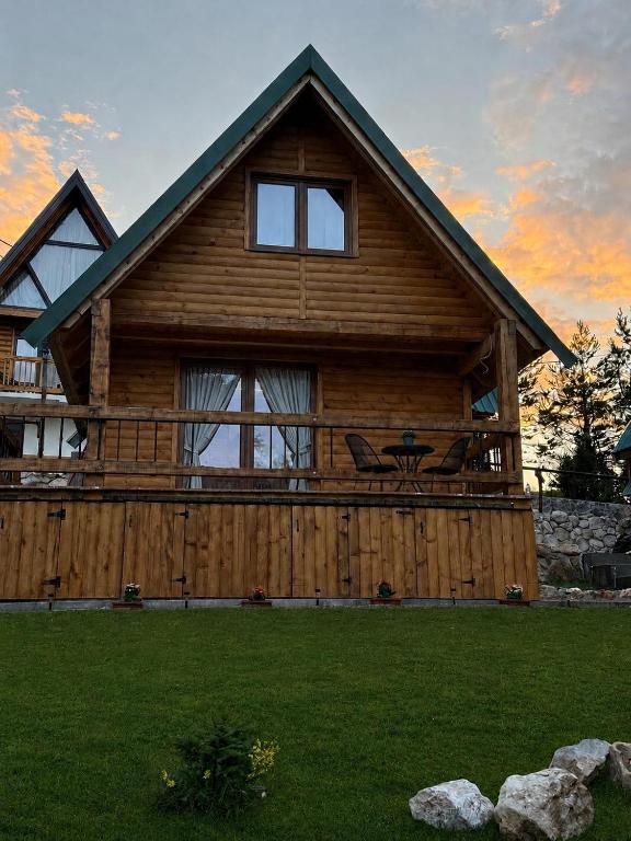 a large wooden cabin with a large window at Stella Alpina in Žabljak