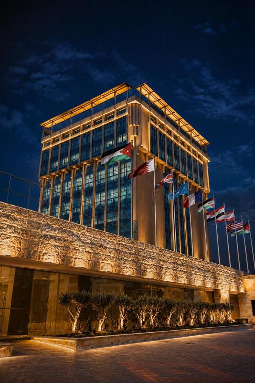 a building with many flags in front of it at The Amman Landmark Hotel in Amman
