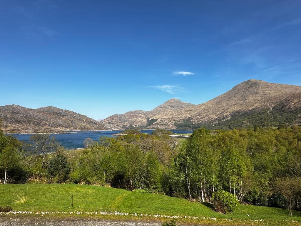 a view of a lake with mountains in the background at Thistle Do in Lochailort