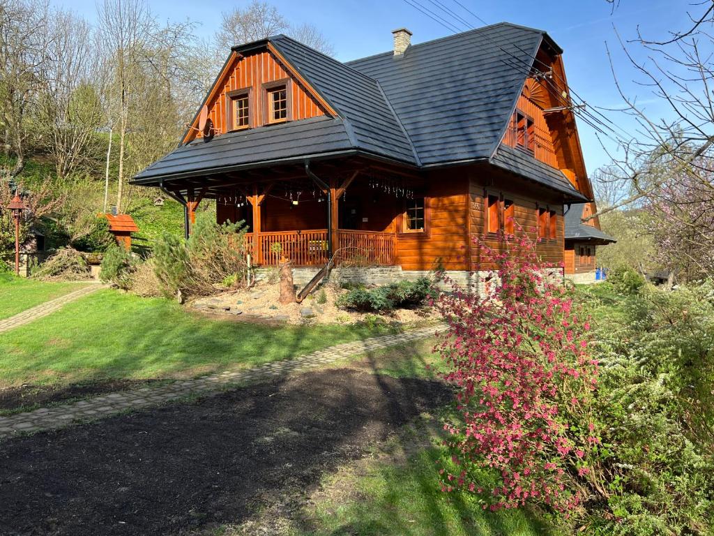 a large wooden house with a black roof at Chata Pod Kohůtkou in Nový Hrozenkov