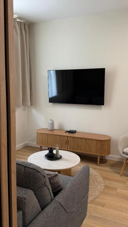 a living room with a tv and a couch and a table at AH Residence Anička in KoÅ¡ickÃ© KÃºpele