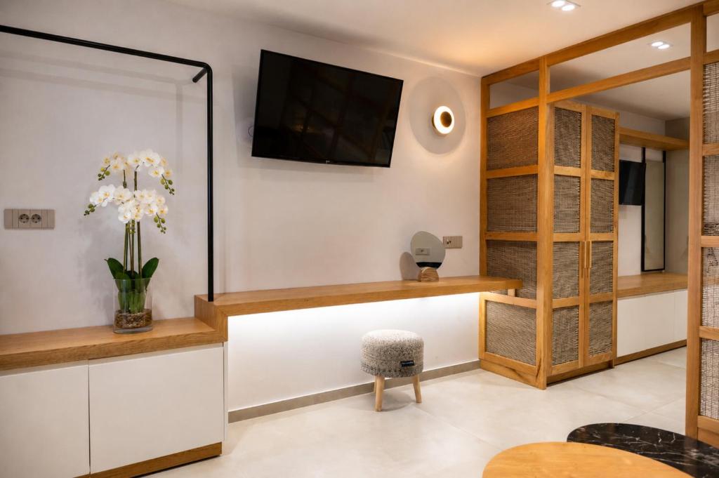 a living room with a tv on the wall at Villa Maraki in Agia Paraskevi