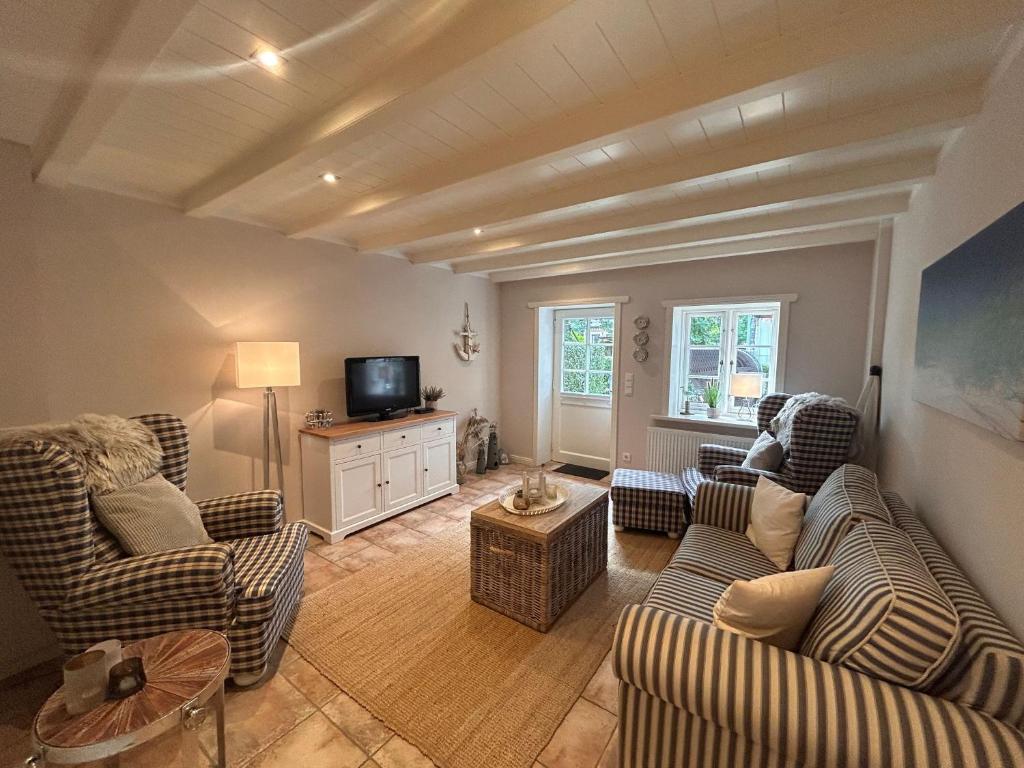 a living room with two couches and a tv at Inseltraum in Wrixum