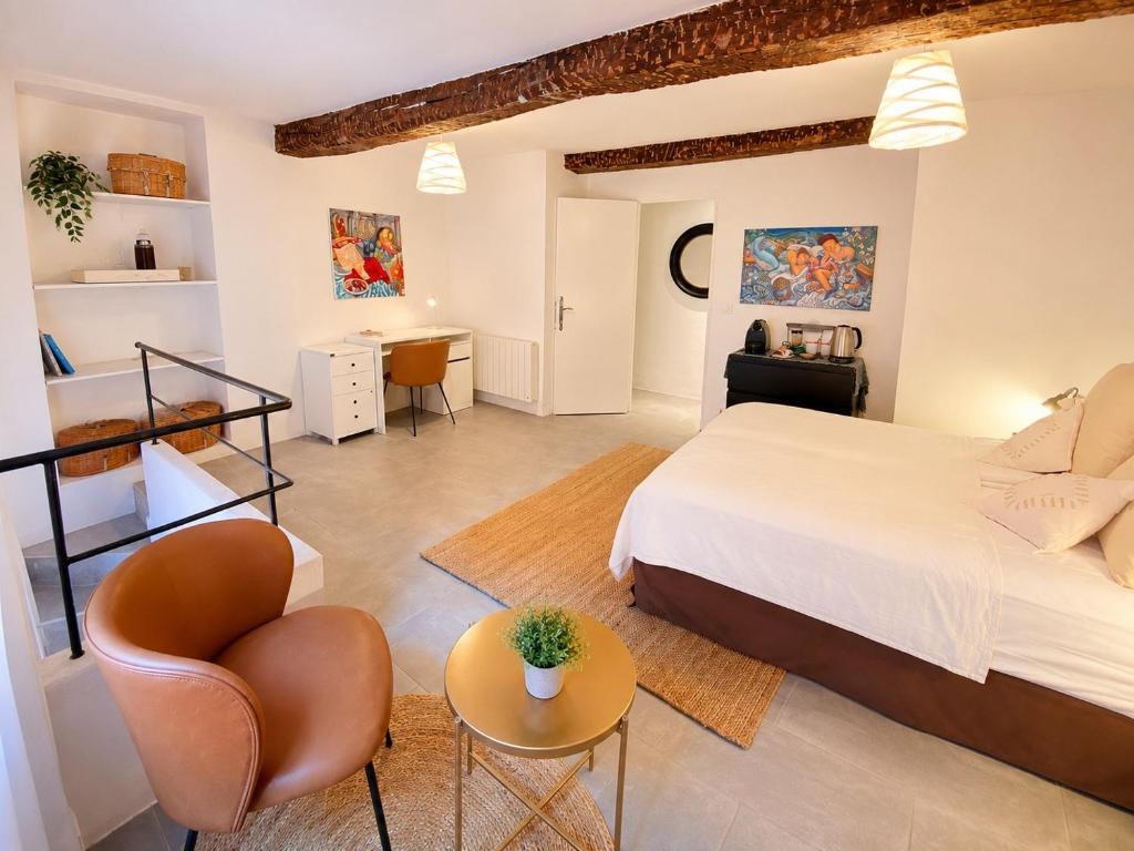 a bedroom with a bed and a chair and a desk at Cabris Village Escape - Junior Suite in Cabris