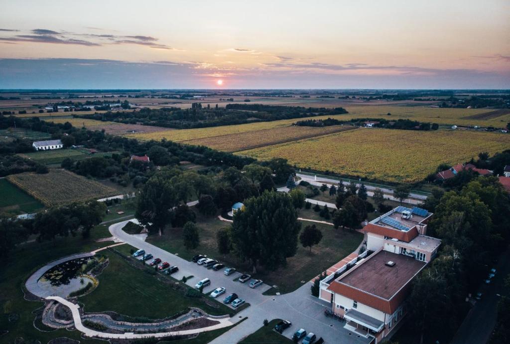 Eine Luftaufnahme eines Gebäudes vor dem Hintergrund eines Sonnenuntergangs. in der Unterkunft Arcanum Hotel in Békéscsaba