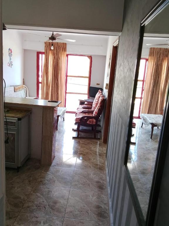 a kitchen and living room with a counter and a table at Super star Chalet in Grand beach in Ras Sedr