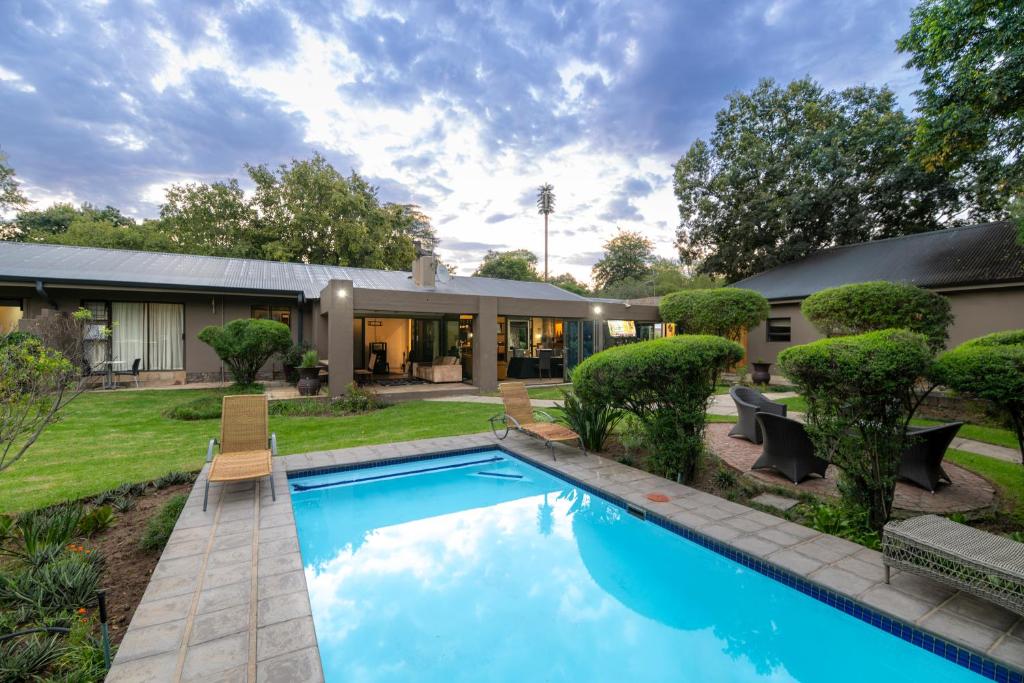 a swimming pool in the yard of a house at Sand River Guest House in Johannesburg