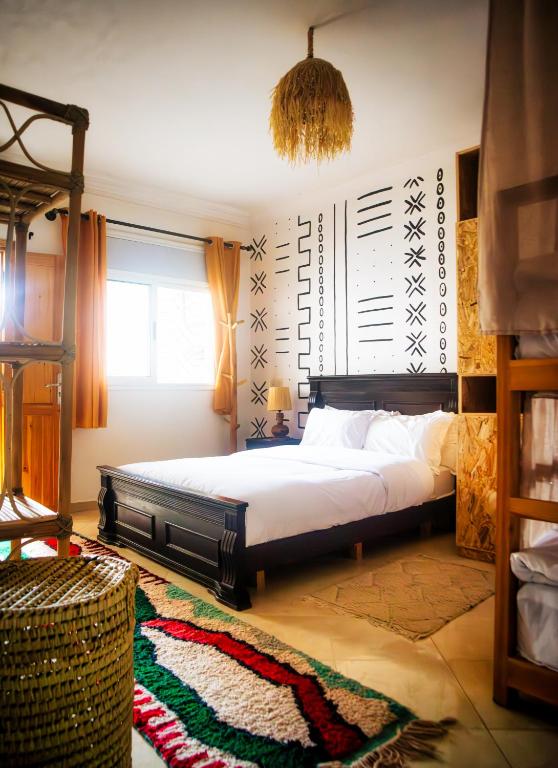 a bedroom with a large bed in a room at Surf and Tribe in Tamraght Ouzdar