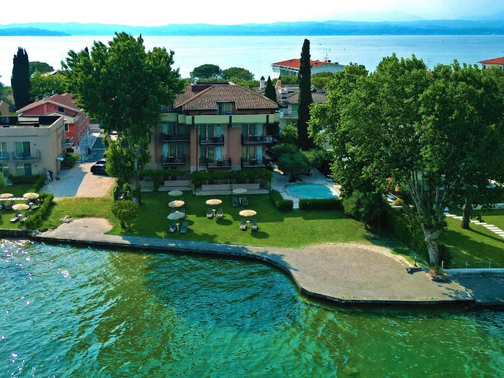 an aerial view of a house on a island in the water at Hotel Smeraldo in Sirmione