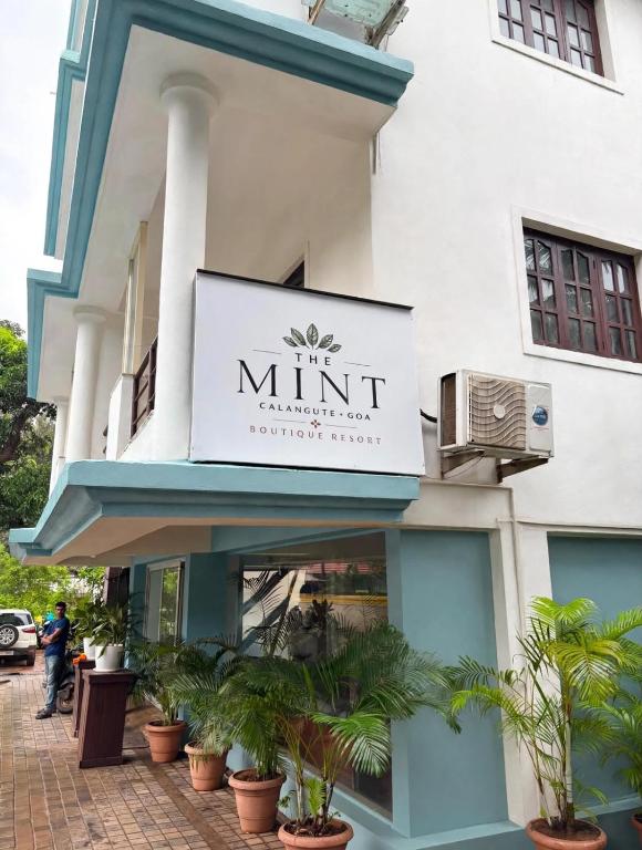 a building with a sign for a minut pharmacy at The Mint Calangute in Calangute