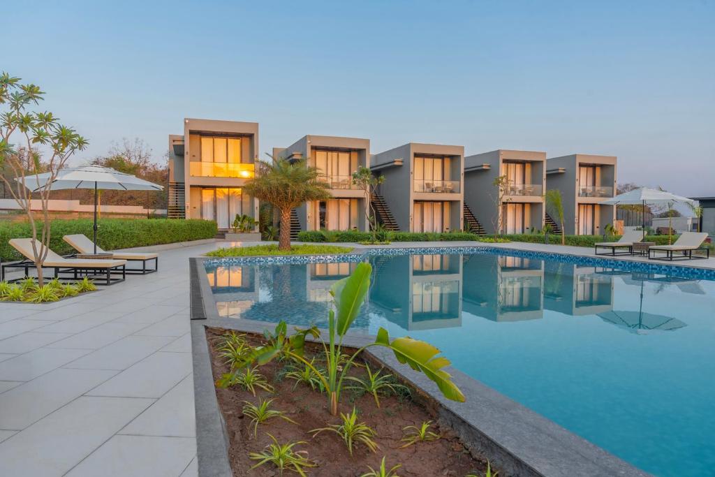 an image of a resort with a swimming pool at Vanam at Sasan in Sasan Gir