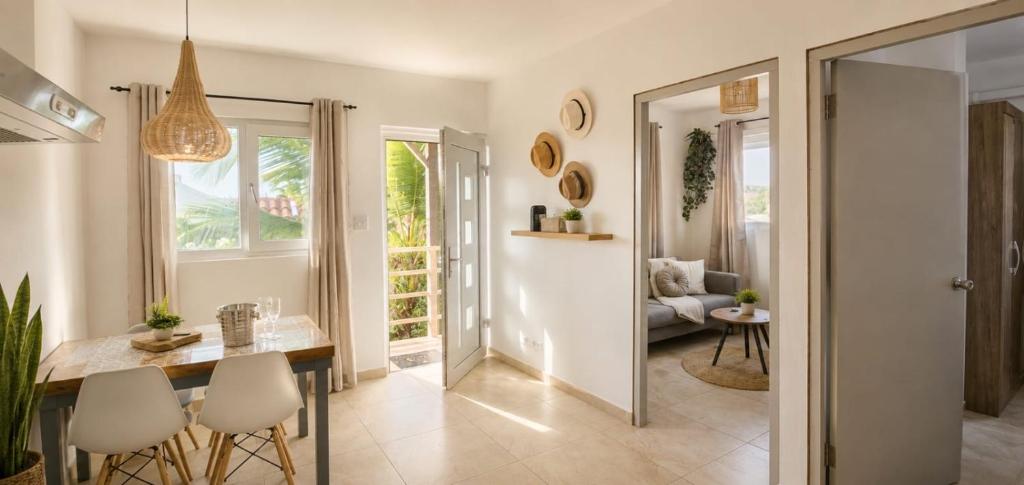a dining room and living room with a table and chairs at Island Vibes Apartment in Noord