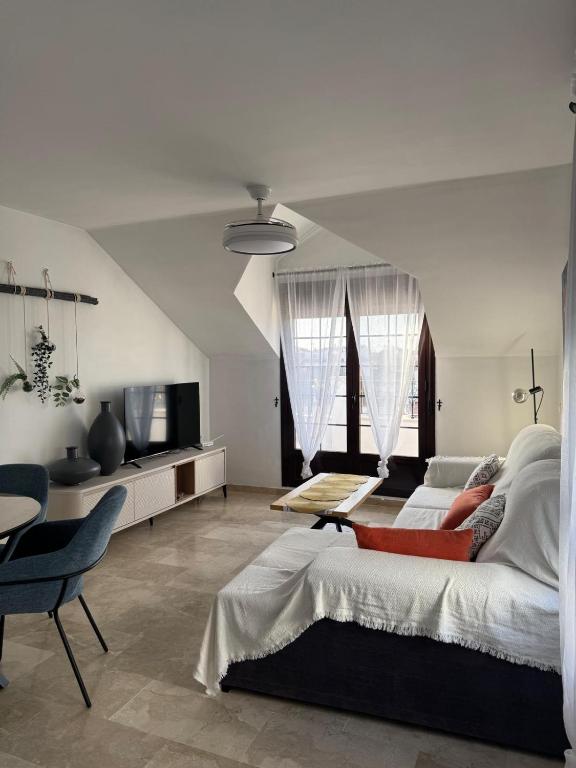 a bedroom with a bed and a table and a tv at Luz del Sur in Antequera
