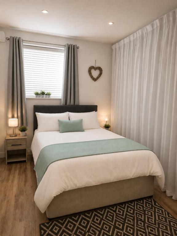 a bedroom with a large bed with a heartigunigunigunigunigunigunigun at Planet 9 in Warrington