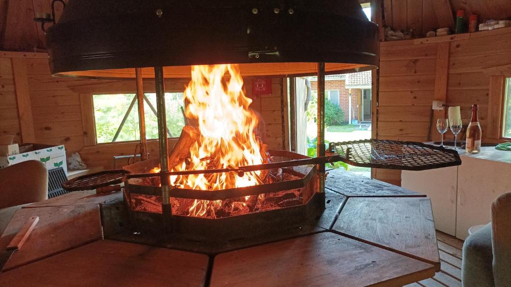 a fire pit in the middle of a room at Half Way in Kalaniemi
