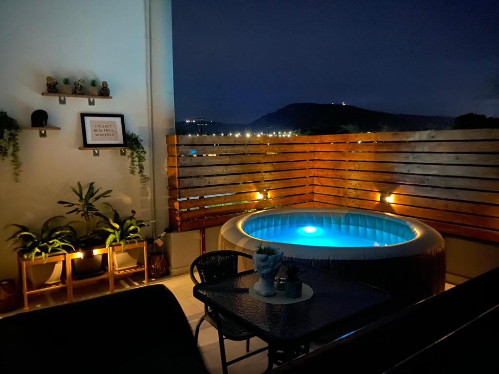 a hot tub sitting on top of a balcony at night at Marvinas seaside apartments, GAIA apartment & HYDOR jacuzzi apartment in Kremasti
